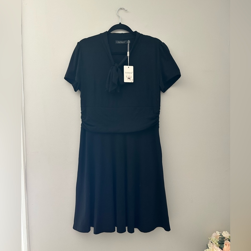NEW WITH TAGS. Black mid length a-line short sleeve tie neck dress